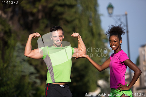 Image of portrait of young multietnic jogging couple ready to run