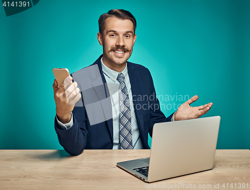 Image of Sad Young Man Working On Laptop At Desk