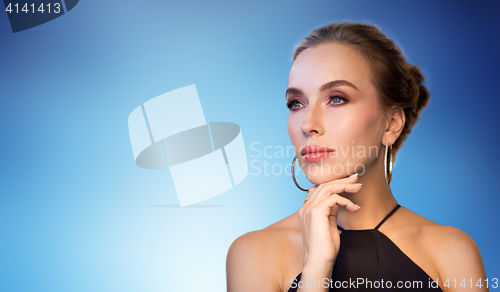 Image of beautiful woman in black wearing diamond jewelry