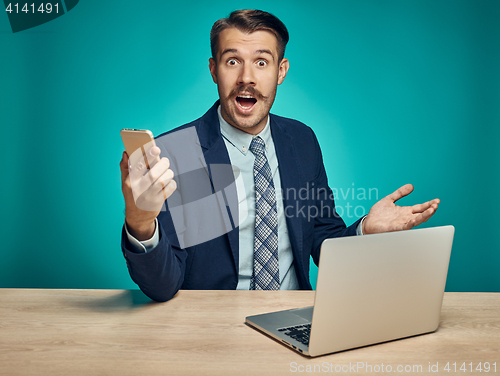 Image of Sad Young Man Working On Laptop At Desk