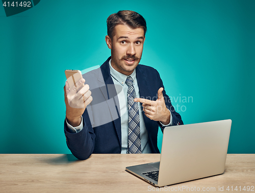 Image of Sad Young Man Working On Laptop At Desk