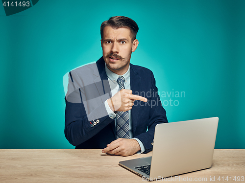 Image of Sad Young Man Working On Laptop At Desk