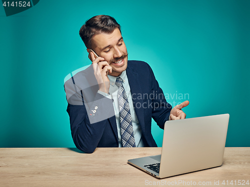 Image of Sad Young Man Working On Laptop At Desk