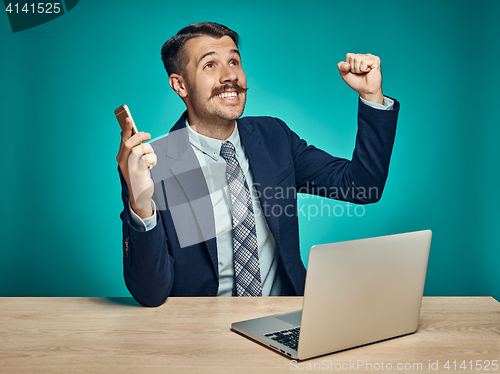 Image of Sad Young Man Working On Laptop At Desk