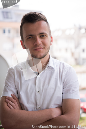 Image of man standing at balcony