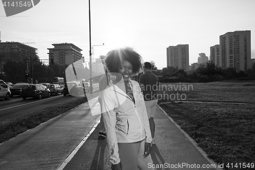 Image of Portrait of sporty young african american woman running outdoors