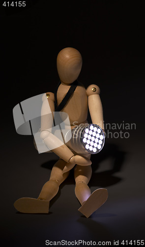 Image of wood mannequin and flashlight