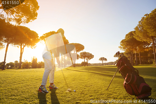 Image of golf player hitting shot with club