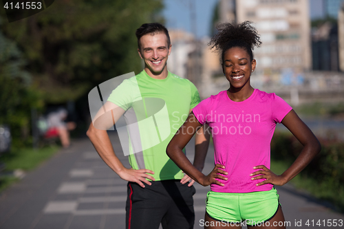 Image of portrait of young multietnic jogging couple ready to run