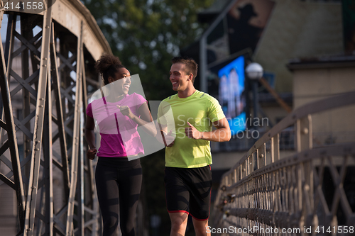Image of multiethnic couple jogging in the city