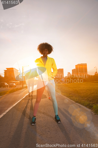 Image of Portrait of sporty young african american woman running outdoors