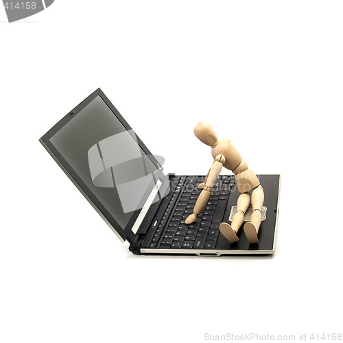 Image of wood mannequin and laptop