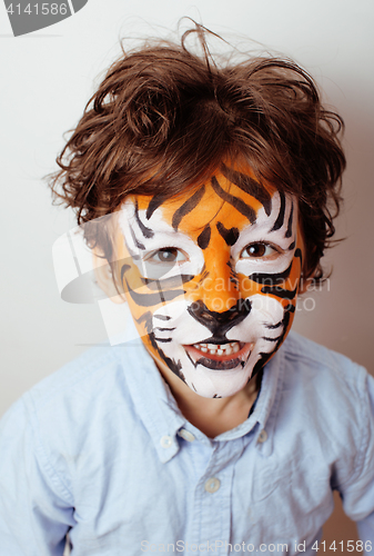 Image of little cute boy with faceart on birthday party close up, little cute tiger