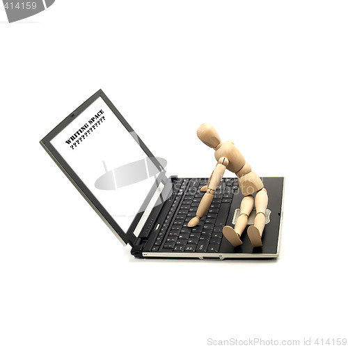 Image of wood mannequin and laptop