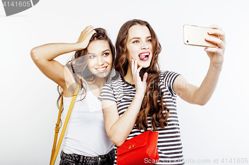 Image of two best friends teenage girls together having fun, posing emotional on white background, besties happy smiling, making selfie, lifestyle people concept