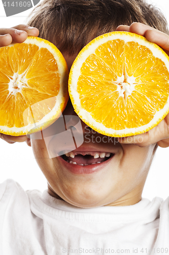 Image of little cute boy with orange fruit double isolated on white smili