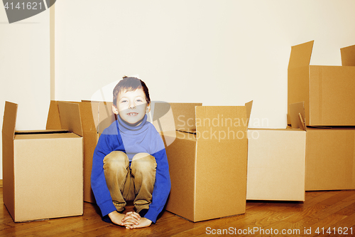 Image of little cute boy in empty room, remoove to new house. home alone, lifestyle people concept