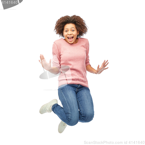 Image of happy african american woman jumping over white