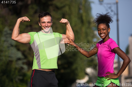 Image of portrait of young multietnic jogging couple ready to run