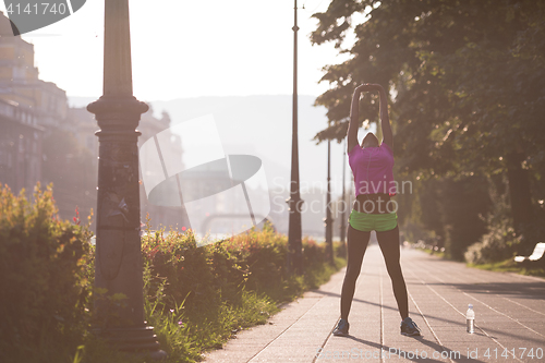 Image of Black woman doing warming up and stretching