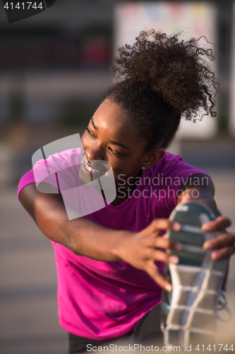 Image of African American woman doing warming up and stretching