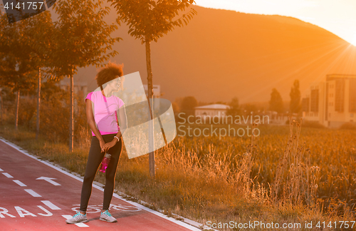 Image of Portrait of a young african american woman running outdoors