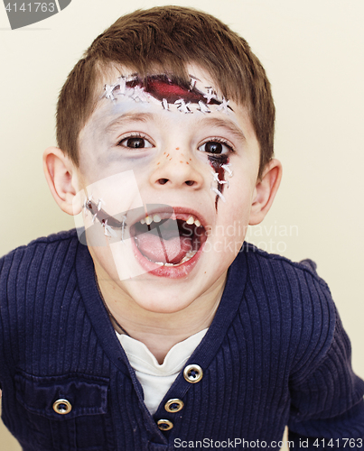 Image of little cute boy with facepaint like zombie apocalypse at hallowe