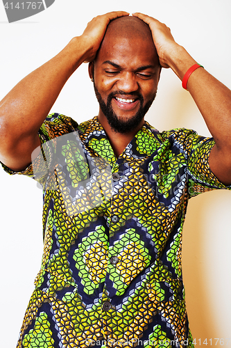 Image of portrait of young handsome african man wearing bright green nati