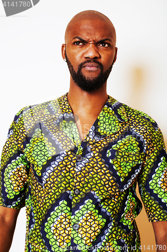 Image of portrait of young handsome african man wearing bright green nati