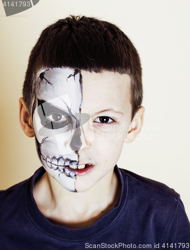 Image of little cute boy with facepaint like skeleton to celebrate hallow