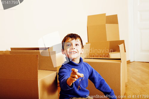 Image of little cute boy in empty room, remoove to new house. home alone, lifestyle people concept