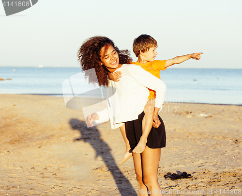 Image of pretty diverse nation and age friends on sea coast having fun, lifestyle people concept on beach vacations