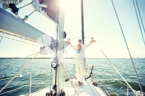 Image of senior couple hugging on sail boat or yacht in sea