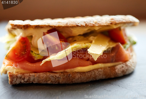 Image of salmon panini sandwich on stone plate