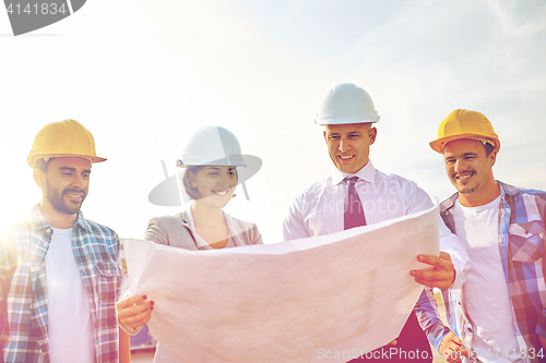 Image of group of builders and architects with blueprint