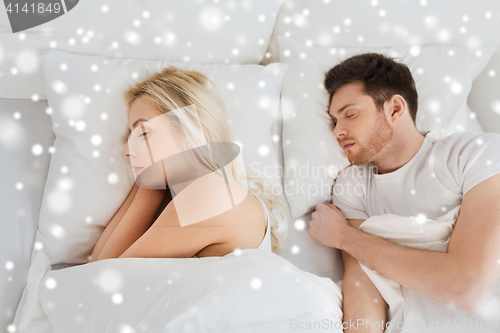 Image of happy couple sleeping in bed at home