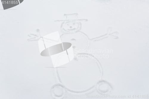 Image of snowman drawing on snow surface