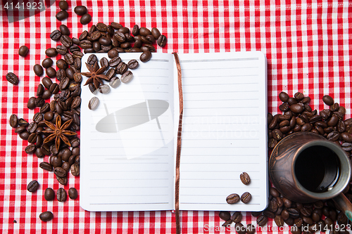 Image of Blank paper, coffe bean and coffee cup on wood