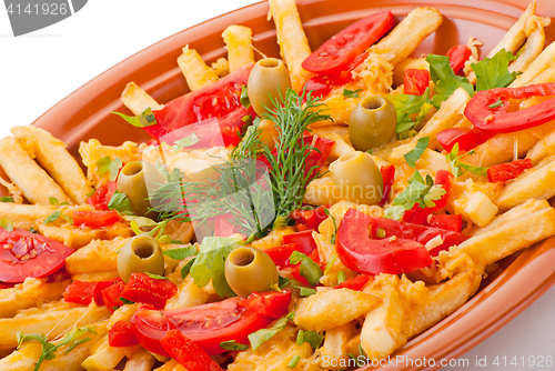 Image of golden French fries potatoes with tomato and olive