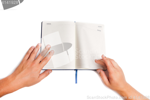 Image of Man hand holding open book isolated on white