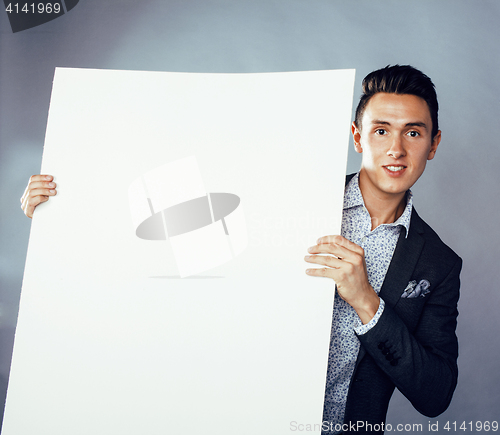 Image of young pretty business man standing on white background, modern hairstyle, posing emotional, lifestyle people concept, holding copyspace shit