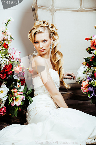 Image of beauty young bride alone in luxury vintage interior with a lot of flowers close up