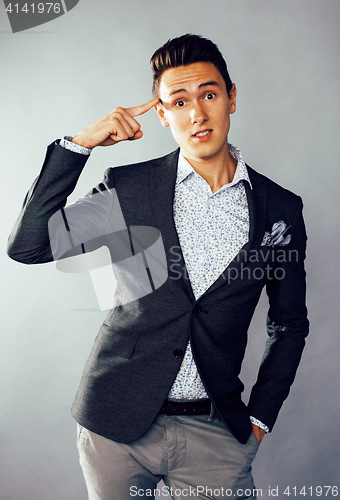 Image of young pretty business man standing on white background, modern hairstyle, posing emotional, lifestyle people concept