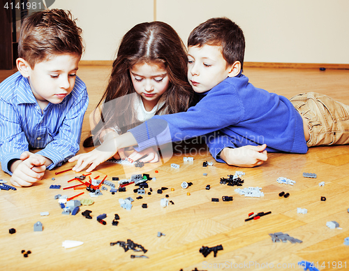 Image of funny cute children playing lego at home, boys and girl smiling, first education role lifestyle
