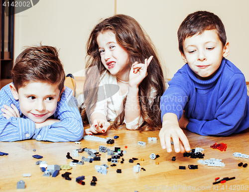 Image of funny cute children playing lego at home, boys and girl smiling, first education role lifestyle