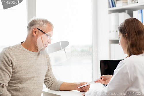 Image of senior man and doctor meeting at hospital