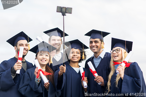 Image of students or bachelors taking selfie by smartphone