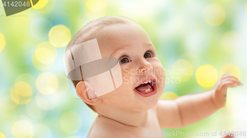 Image of happy little baby boy or girl looking up