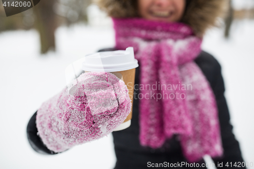 Image of close up of hand with coffee outdoors in winter