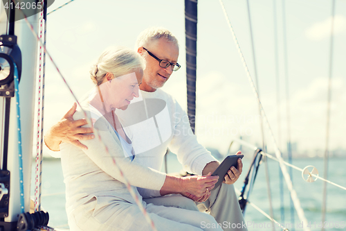 Image of senior couple with tablet pc on sail boat or yacht